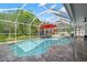 Screened-in pool area features a large pool, lounge chairs, and a patio set for outdoor relaxation at 9905 Woodbay Dr, Tampa, FL 33626