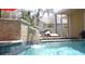 Pool features a stone waterfall feature adding natural appeal to the backyard at 9905 Woodbay Dr, Tampa, FL 33626