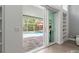 View from inside to the screened pool area with an umbrella covered table at 9905 Woodbay Dr, Tampa, FL 33626