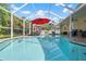 Screened pool area with outdoor dining and lounging space for entertaining at 9905 Woodbay Dr, Tampa, FL 33626