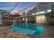 Beautiful screened-in pool with an umbrella, patio furniture, and tile flooring at 9905 Woodbay Dr, Tampa, FL 33626