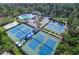 Aerial view of the tennis courts, pool, and parking lot at the Avalon at the Pine Ridge community at 9905 Woodbay Dr, Tampa, FL 33626