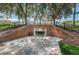 Tunnel beneath a tree-covered hill with brick retaining walls and black metal railings at Avalon at Pine Ridge at 9905 Woodbay Dr, Tampa, FL 33626