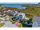 Coastal home with backyard pool, well-manicured lawn and tropical landscaping near bay at 13936 Harbor View Dr, Seminole, FL 33776