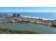 Scenic aerial view of coastal town, calm waterways, and beautiful sandy beach at 13936 Harbor View Dr, Seminole, FL 33776
