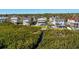 Aerial view of waterfront homes, canal, dock and lush green landscaping in quiet neighborhood at 13936 Harbor View Dr, Seminole, FL 33776