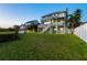 Expansive backyard with lush green grass and a white fence, perfect for outdoor activities at 13936 Harbor View Dr, Seminole, FL 33776