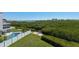 Aerial view of a backyard with a pool, a lawn and a dock at 13936 Harbor View Dr, Seminole, FL 33776
