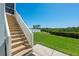 Expansive backyard with lush lawn, stairs, and partial views of nearby buildings at 13936 Harbor View Dr, Seminole, FL 33776