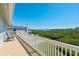 Spacious balcony with wood flooring, white railings, and views of the bay at 13936 Harbor View Dr, Seminole, FL 33776
