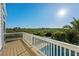 Balcony overlooking a tropical landscape and sparkling pool below, perfect for relaxation at 13936 Harbor View Dr, Seminole, FL 33776