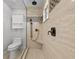 Bathroom featuring travertine tile, a shower bench, and a glass shower surround at 13936 Harbor View Dr, Seminole, FL 33776