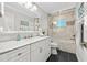 Bathroom with a shower-tub combo, marble countertops, and bronze fixtures at 13936 Harbor View Dr, Seminole, FL 33776