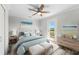 Bedroom features a ceiling fan, ensuite bath, and water views at 13936 Harbor View Dr, Seminole, FL 33776