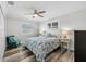 Bedroom with a ceiling fan, hardwood floors, and plenty of natural light from the two windows at 13936 Harbor View Dr, Seminole, FL 33776