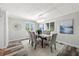 Dining room with a modern chandelier, seating for six, and sunny windows at 13936 Harbor View Dr, Seminole, FL 33776