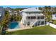 Two-story home with large pool, screened balconies, lush lawn and staircase to backyard at 13936 Harbor View Dr, Seminole, FL 33776