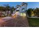 Charming two-story home featuring a paved driveway, tropical landscaping, and a welcoming entrance at 13936 Harbor View Dr, Seminole, FL 33776