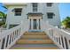 Inviting front entrance with a grand staircase, stylish doors, and manicured landscaping at 13936 Harbor View Dr, Seminole, FL 33776