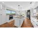 Modern kitchen with a large island, custom cabinetry, stainless steel appliances, and terra cotta flooring at 13936 Harbor View Dr, Seminole, FL 33776