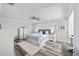 Spacious main bedroom features a ceiling fan, luxury vinyl plank flooring, and natural light at 13936 Harbor View Dr, Seminole, FL 33776