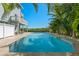 Stunning swimming pool bordered by mature palm trees and meticulous landscaping at 13936 Harbor View Dr, Seminole, FL 33776