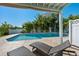 Relaxing pool area surrounded by lush tropical landscaping and comfortable lounge chairs at 13936 Harbor View Dr, Seminole, FL 33776