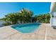Inviting pool area surrounded by tropical foliage and a spacious patio at 13936 Harbor View Dr, Seminole, FL 33776