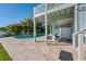 Outdoor patio space with pool and covered area with stairway to second floor at 13936 Harbor View Dr, Seminole, FL 33776