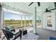 A screened porch features comfortable seating and views of the marsh at 13936 Harbor View Dr, Seminole, FL 33776