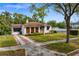 Charming single-story home featuring a well-manicured lawn and brick-paved driveway at 2925 W Alline Ave, Tampa, FL 33611