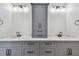 This bathroom features marble countertops, dual sinks, gray cabinets, and matte black hardware at 1045 Jesse Ave, Safety Harbor, FL 34695