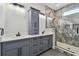 Bathroom featuring double sink vanity with storage and glass enclosed shower at 1045 Jesse Ave, Safety Harbor, FL 34695