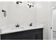 Bathroom featuring double vanity with marble countertop and modern black fixtures at 1045 Jesse Ave, Safety Harbor, FL 34695