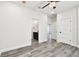 Spacious bedroom with wood-look floors, white walls, recessed lighting, and ensuite bathroom at 1045 Jesse Ave, Safety Harbor, FL 34695