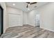 This bedroom boasts recessed lighting, white walls, wood look flooring, and a ceiling fan at 1045 Jesse Ave, Safety Harbor, FL 34695