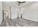 Bedroom features gray wood flooring, ceiling fan, recessed lighting, and access to other rooms at 1045 Jesse Ave, Safety Harbor, FL 34695