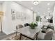 Elegant dining room with a marble-topped table, modern chairs, and a view leading to the kitchen and outdoor area at 1045 Jesse Ave, Safety Harbor, FL 34695
