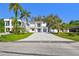 Stunning two-story home with a blue door, attached garage, and a spacious paver driveway at 1045 Jesse Ave, Safety Harbor, FL 34695