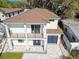 Beautiful modern home featuring a balcony, a large window, and a two-car garage at 1045 Jesse Ave, Safety Harbor, FL 34695
