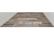 Gray wood flooring with white baseboards at 1045 Jesse Ave, Safety Harbor, FL 34695