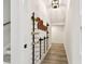 Cozy hallway with decoratively displayed wine collection and wooden floors, leading to other rooms at 1045 Jesse Ave, Safety Harbor, FL 34695