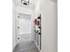 Hallway featuring gray wood floors and a black wine rack with various wine bottles on display at 1045 Jesse Ave, Safety Harbor, FL 34695