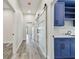 Hallway with sliding doors, blue cabinets with marble countertops, and wood look flooring at 1045 Jesse Ave, Safety Harbor, FL 34695