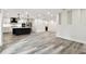 Open concept kitchen featuring an island, stainless steel appliances and gray wood floors at 1045 Jesse Ave, Safety Harbor, FL 34695