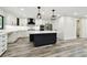 Bright kitchen with black island, marble countertop, and stainless steel appliances at 1045 Jesse Ave, Safety Harbor, FL 34695