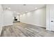 Spacious living room with hardwood floors, recessed lighting, and an open layout that flows into the kitchen area at 1045 Jesse Ave, Safety Harbor, FL 34695