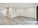 Open living room area with gray wood floors and a glass door leading to the outdoors at 1045 Jesse Ave, Safety Harbor, FL 34695