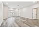 Inviting living room featuring hardwood floors and an open space layout with doors leading to outdoor areas at 1045 Jesse Ave, Safety Harbor, FL 34695
