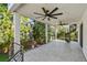 Expansive outdoor patio featuring neutral tiling, modern railing, and ceiling fans for comfort and style at 1045 Jesse Ave, Safety Harbor, FL 34695